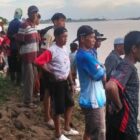 Warga menyaksikan Tim SAR Gabungan melakukan operasi pencarian seorang bocah yang hanyut di Sungai Batanghari | sar
